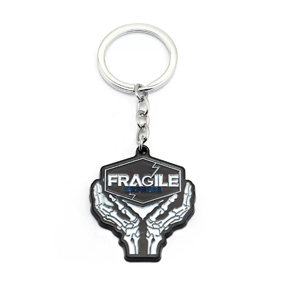 Black metal keychain with FRAGILE lettering — durable accessory.