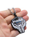 FRAGILE pendant — silver engraved text on weathered finish.